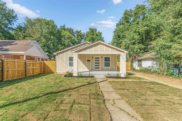 view of front of home featuring covered porch and a front yard