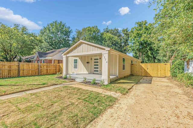 view of front of property with covered porch and a front yard