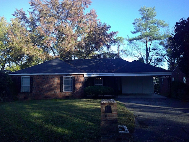 ranch-style house with a front lawn and a carport