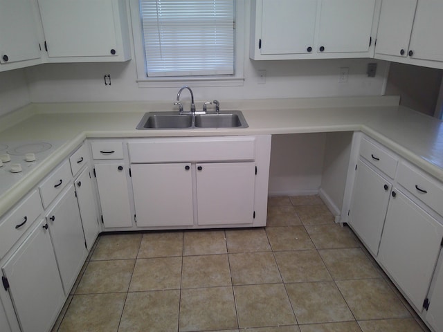 kitchen with white cabinetry, sink, and light tile patterned floors