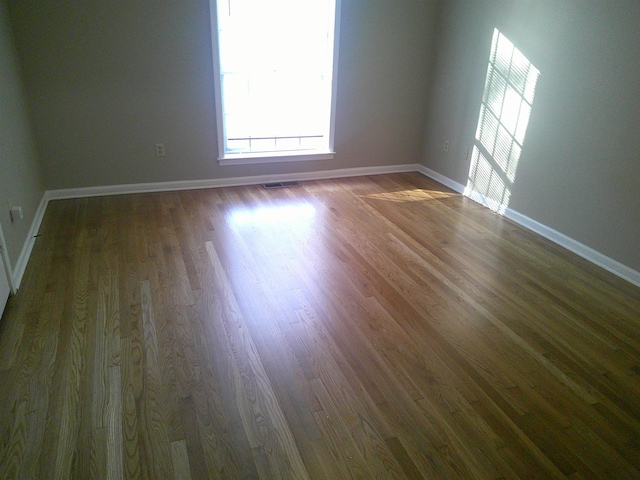 empty room featuring dark hardwood / wood-style floors