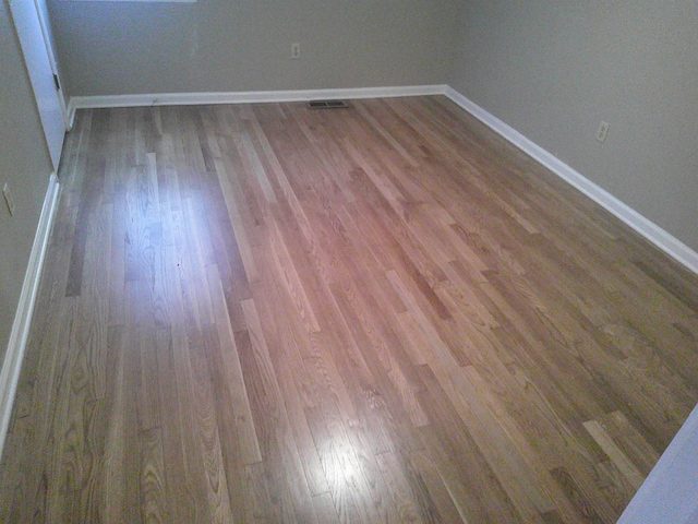 spare room with wood-type flooring