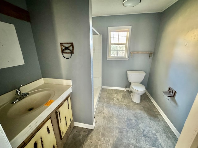 bathroom featuring vanity, toilet, and walk in shower