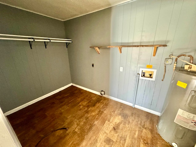 clothes washing area with hookup for an electric dryer, hookup for a washing machine, electric water heater, a textured ceiling, and hardwood / wood-style flooring