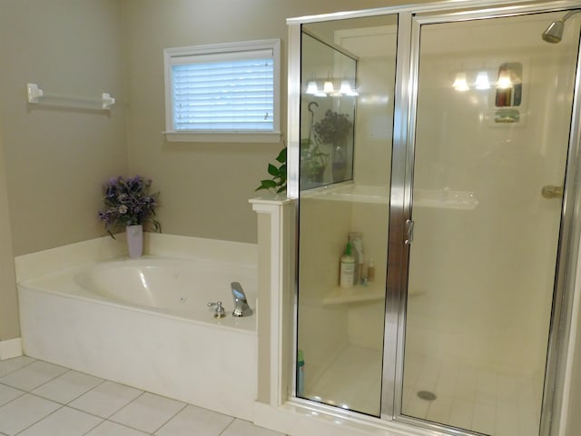 bathroom with separate shower and tub and tile patterned floors