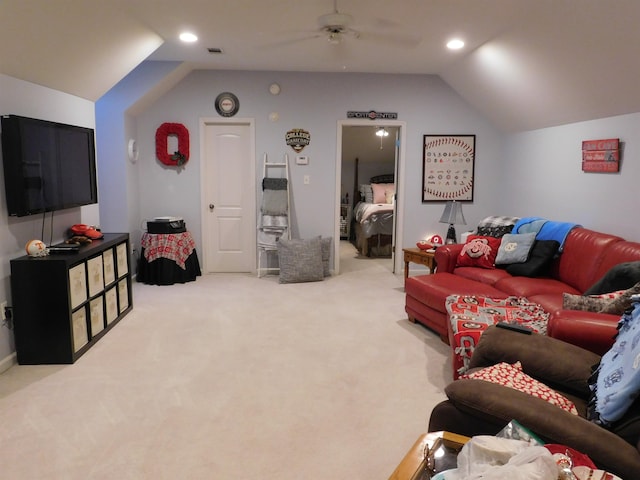 living room featuring vaulted ceiling, ceiling fan, and carpet