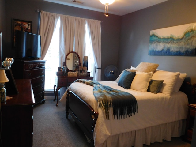 bedroom with dark colored carpet