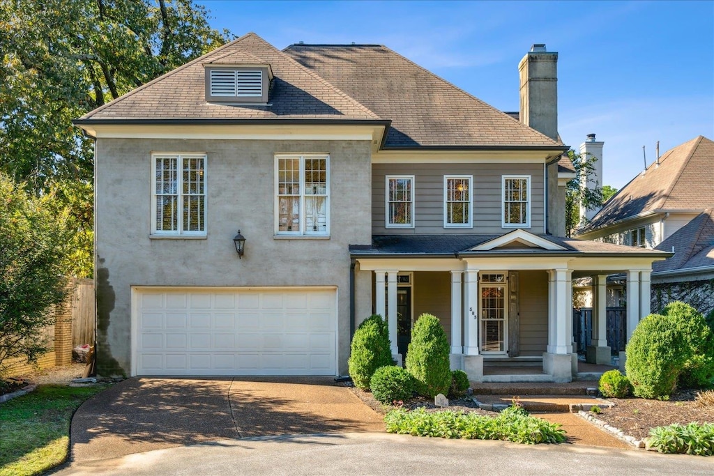 view of front of property featuring covered porch and a garage