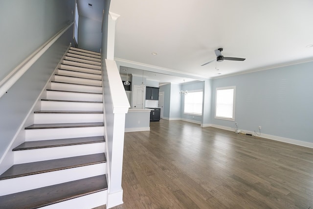 stairway with hardwood / wood-style flooring, ceiling fan, and crown molding