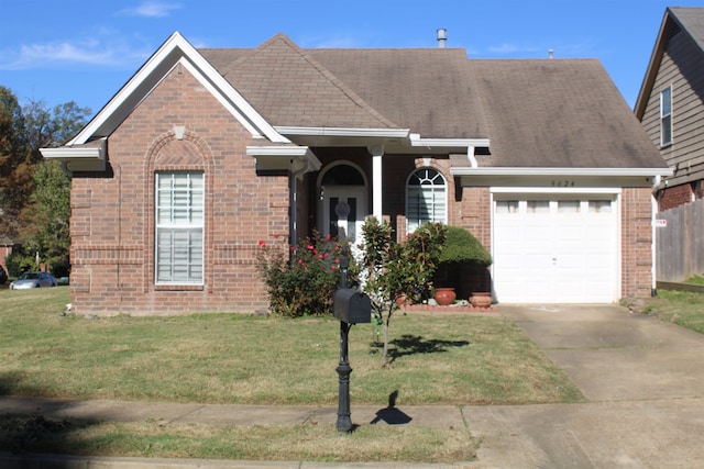 view of front facade with a garage and a front yard