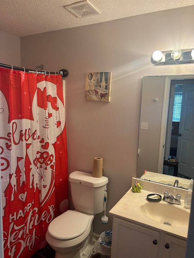 bathroom featuring vanity, a textured ceiling, toilet, and a shower with shower curtain