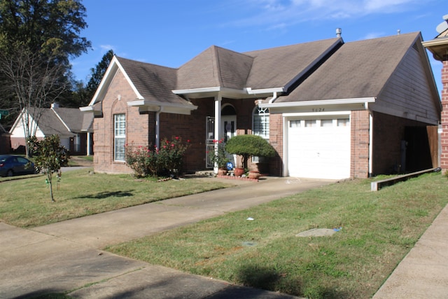 view of front of property with a front yard and a garage