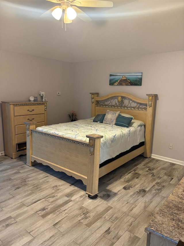 bedroom featuring light hardwood / wood-style flooring and ceiling fan