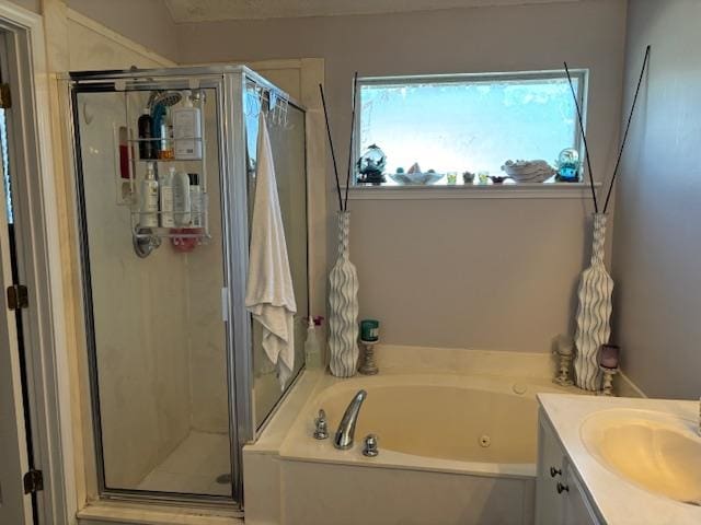 bathroom with vanity and independent shower and bath