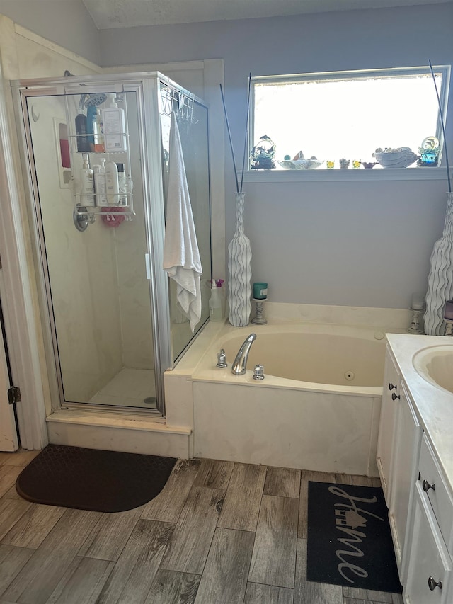 bathroom featuring hardwood / wood-style floors, vanity, and independent shower and bath