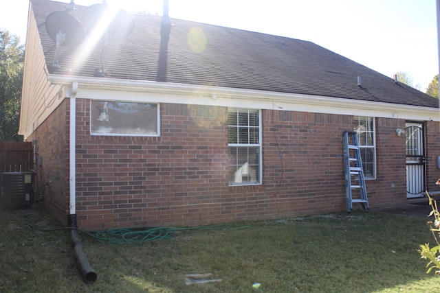 view of home's exterior featuring cooling unit and a yard