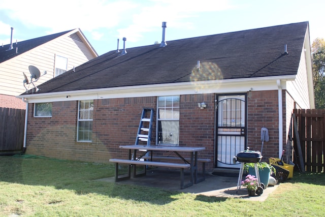 rear view of property with a patio area and a lawn