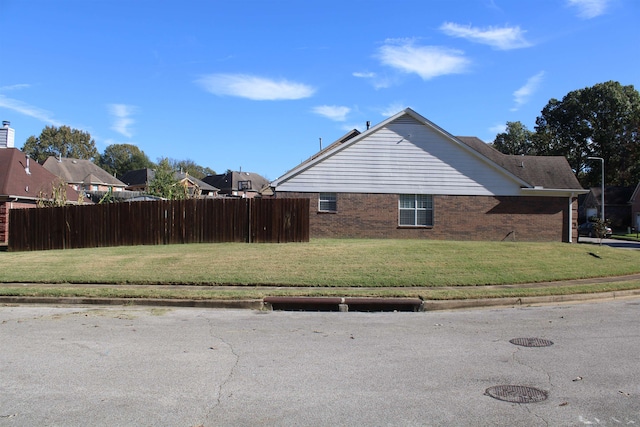 view of side of property with a lawn