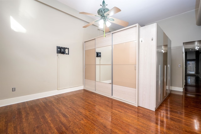 unfurnished bedroom featuring ceiling fan, a closet, and dark hardwood / wood-style floors