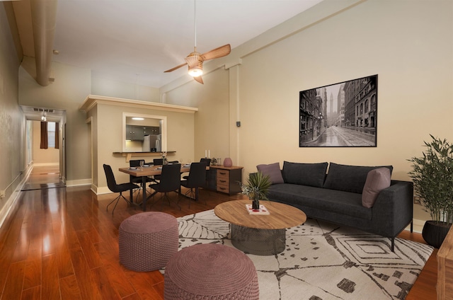 living room with ceiling fan and wood-type flooring