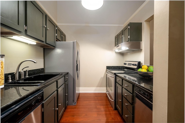 71 Union Ave Unit 102, Memphis, TN 38103 - kitchen featuring appliances with stainless steel finishes, under cabinet range hood, a sink, dark stone counters, and dark wood-type flooring