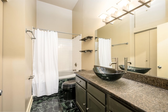 71 Union Ave Unit 102, Memphis, TN 38103 - bathroom featuring shower / tub combo with curtain, marble finish flooring, vanity, and toilet