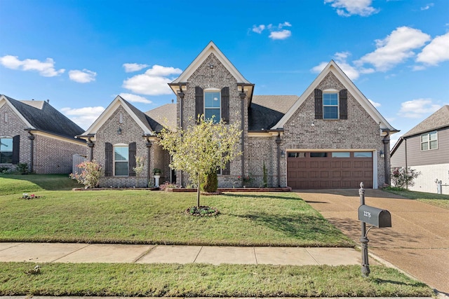 view of front of property featuring a front yard and a garage