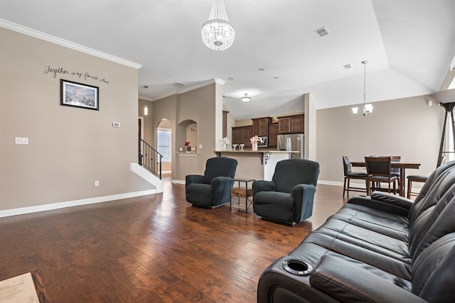 living room with a chandelier, ornamental molding, vaulted ceiling, and dark wood-type flooring