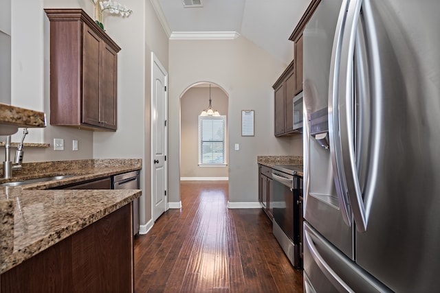 kitchen featuring dark hardwood / wood-style flooring, ornamental molding, stainless steel appliances, vaulted ceiling, and stone countertops