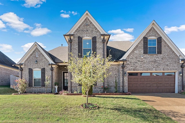 view of front of home with a front lawn and a garage