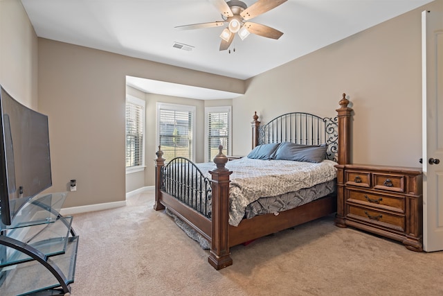 bedroom with light carpet and ceiling fan