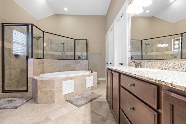 bathroom featuring tile patterned flooring, vanity, shower with separate bathtub, and vaulted ceiling