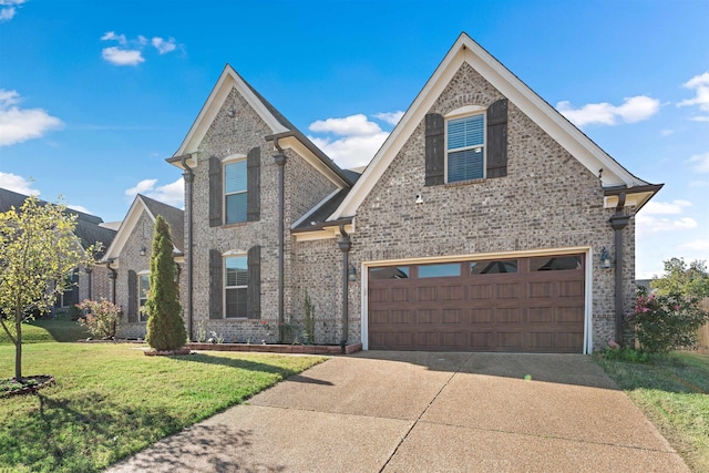 view of front of property with a front lawn and a garage