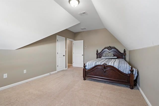 carpeted bedroom with vaulted ceiling