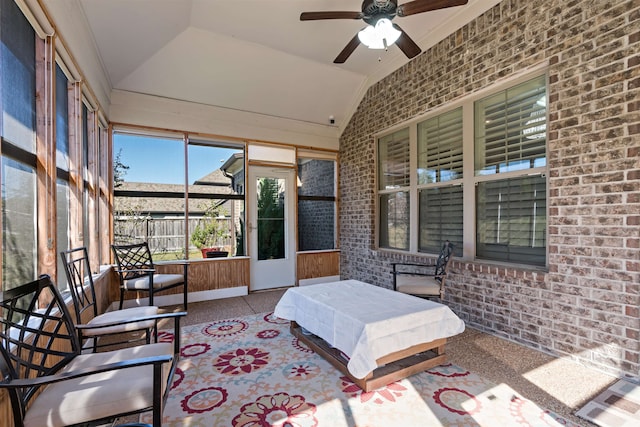 sunroom with ceiling fan and vaulted ceiling