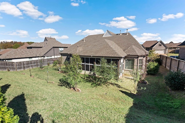 rear view of house with a yard