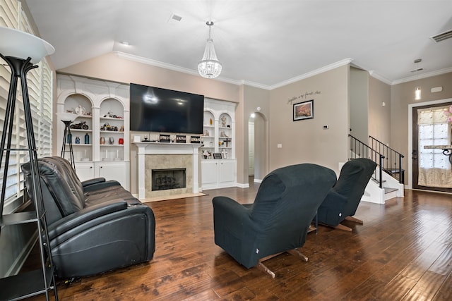 living room featuring hardwood / wood-style flooring, crown molding, and a chandelier