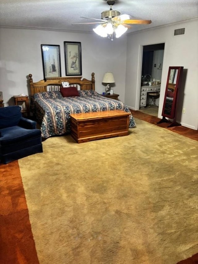 bedroom featuring ceiling fan, carpet floors, a textured ceiling, and connected bathroom