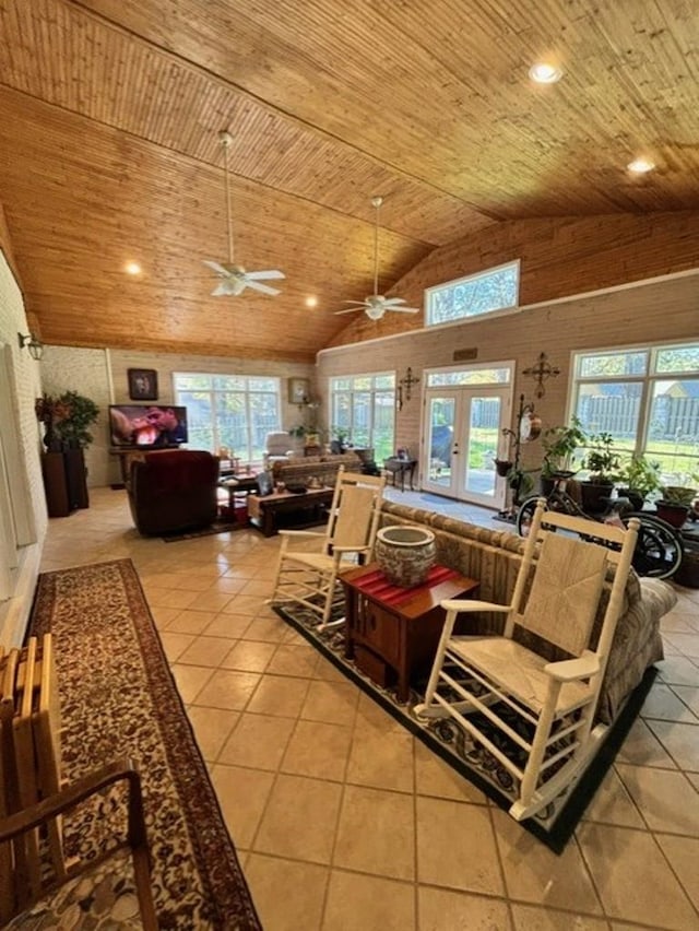 tiled living room with french doors, high vaulted ceiling, ceiling fan, and wooden ceiling