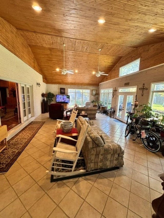 tiled living room with a wealth of natural light, french doors, and wooden ceiling