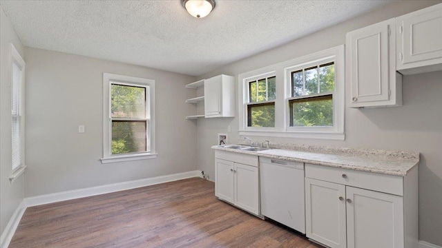 kitchen featuring white cabinets, dark hardwood / wood-style flooring, a textured ceiling, and a wealth of natural light