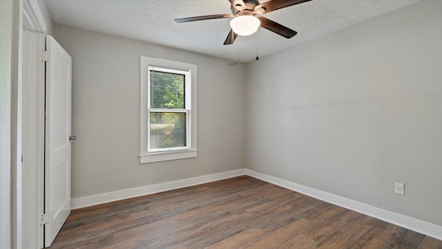 unfurnished room featuring a textured ceiling, ceiling fan, and dark hardwood / wood-style floors