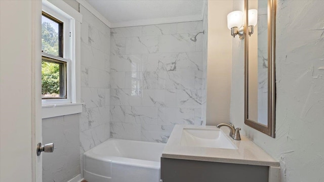 bathroom with vanity and tiled shower / bath