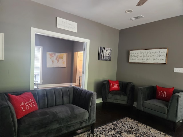 living room with ceiling fan and dark hardwood / wood-style flooring