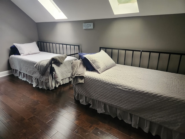 bedroom with vaulted ceiling and dark wood-type flooring