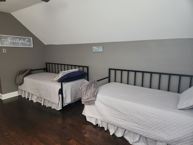 bedroom with dark hardwood / wood-style floors and vaulted ceiling