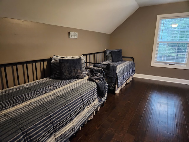 bedroom with dark hardwood / wood-style flooring and lofted ceiling