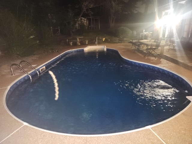 pool at night with a patio