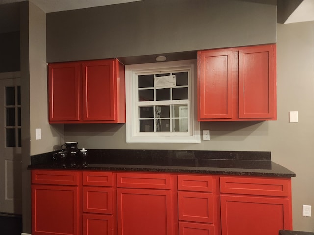 kitchen featuring dark stone countertops