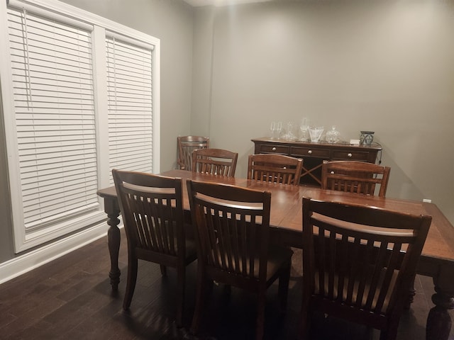 dining space with dark wood-type flooring